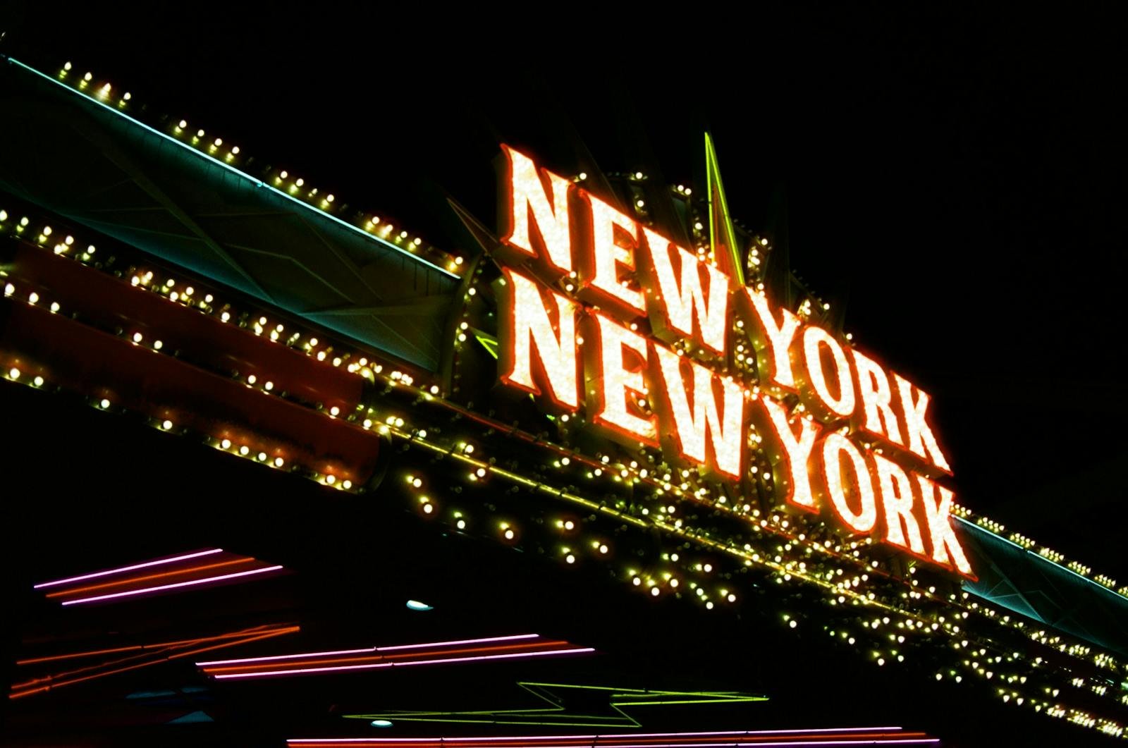 Bright neon lights of the New York New York sign glowing at night in vibrant colors.