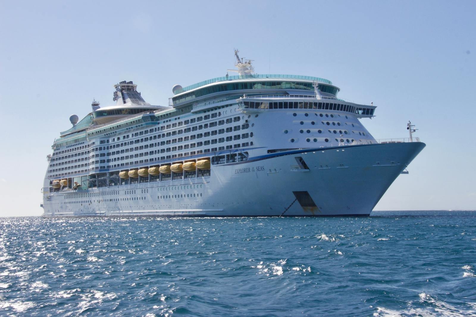 A luxurious cruise ship sailing on the ocean under a clear blue sky, ideal for travel and leisure.